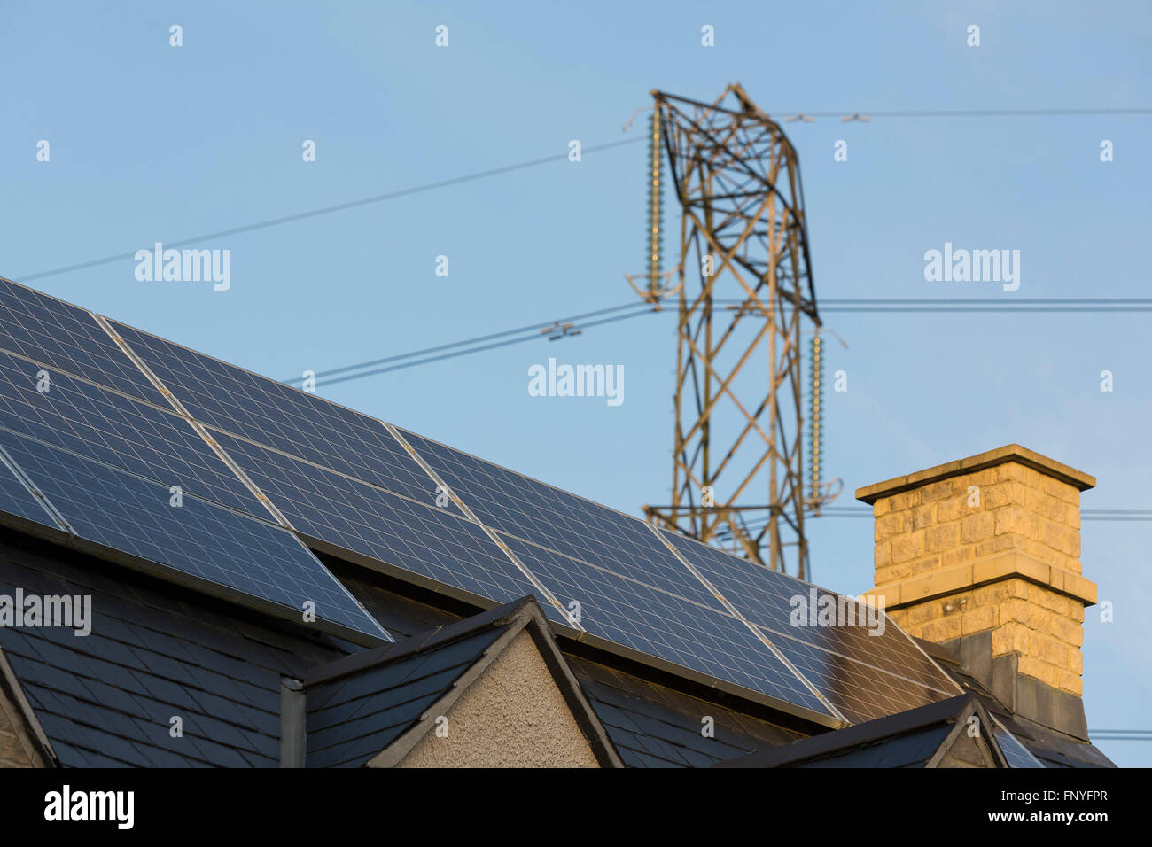 Solar panels and tiles on residential housing in the UK. Stock Photo