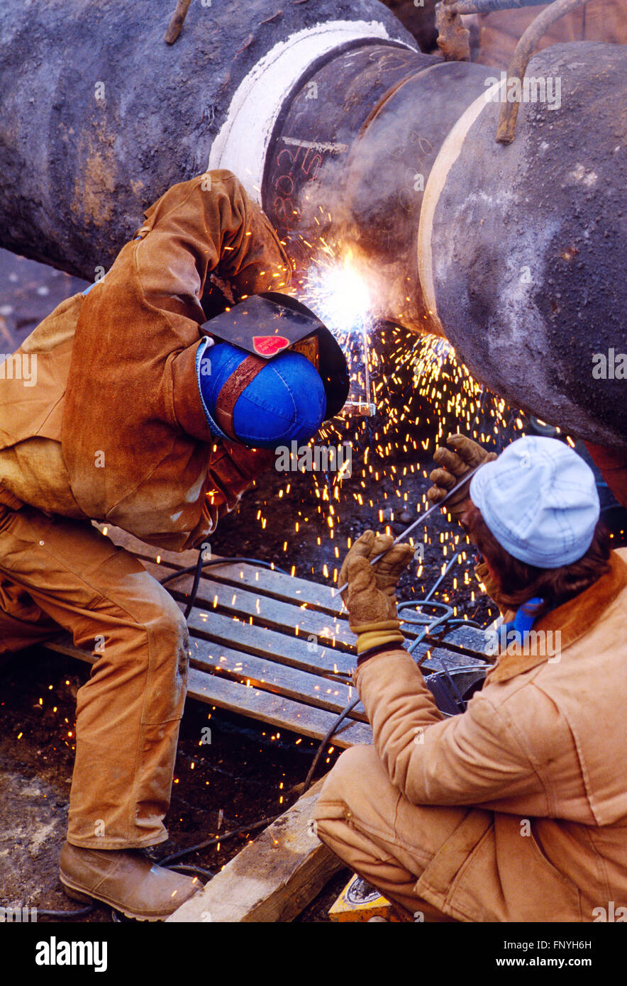 Man welding a gas pipeline seam for installation under the Delaware River; rural Pennsylvania; USA Stock Photo