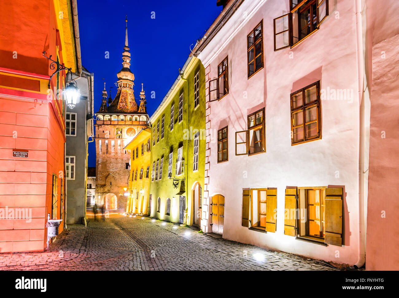 Sighisoara in Romania. Night view of clock tower in historic medieval city. Vlad Tepes, Dracula, was born here. Stock Photo