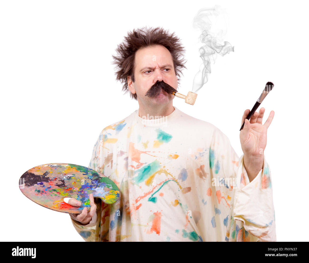Concentrated painter paints and smoking from tobacco pipe Stock Photo