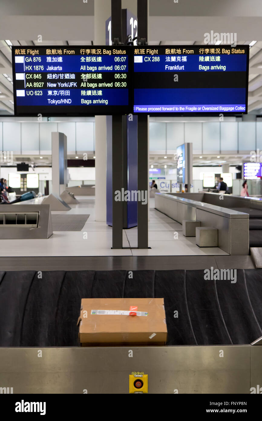 packet on the conveyor under bags arrival schedule at airport terminal Stock Photo