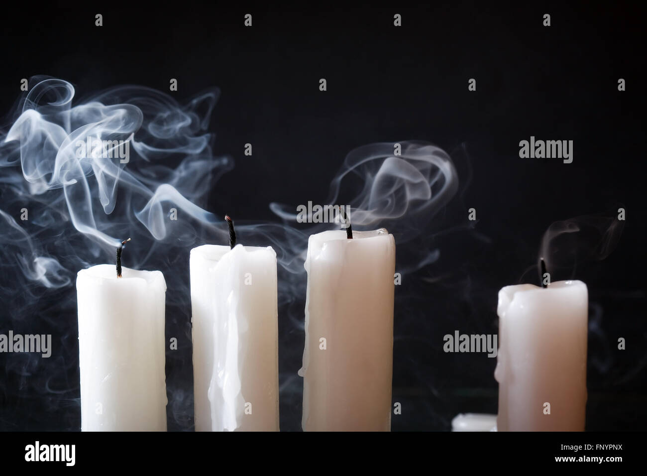 https://c8.alamy.com/comp/FNYPNX/few-extinguished-candles-in-a-row-on-dark-background-FNYPNX.jpg