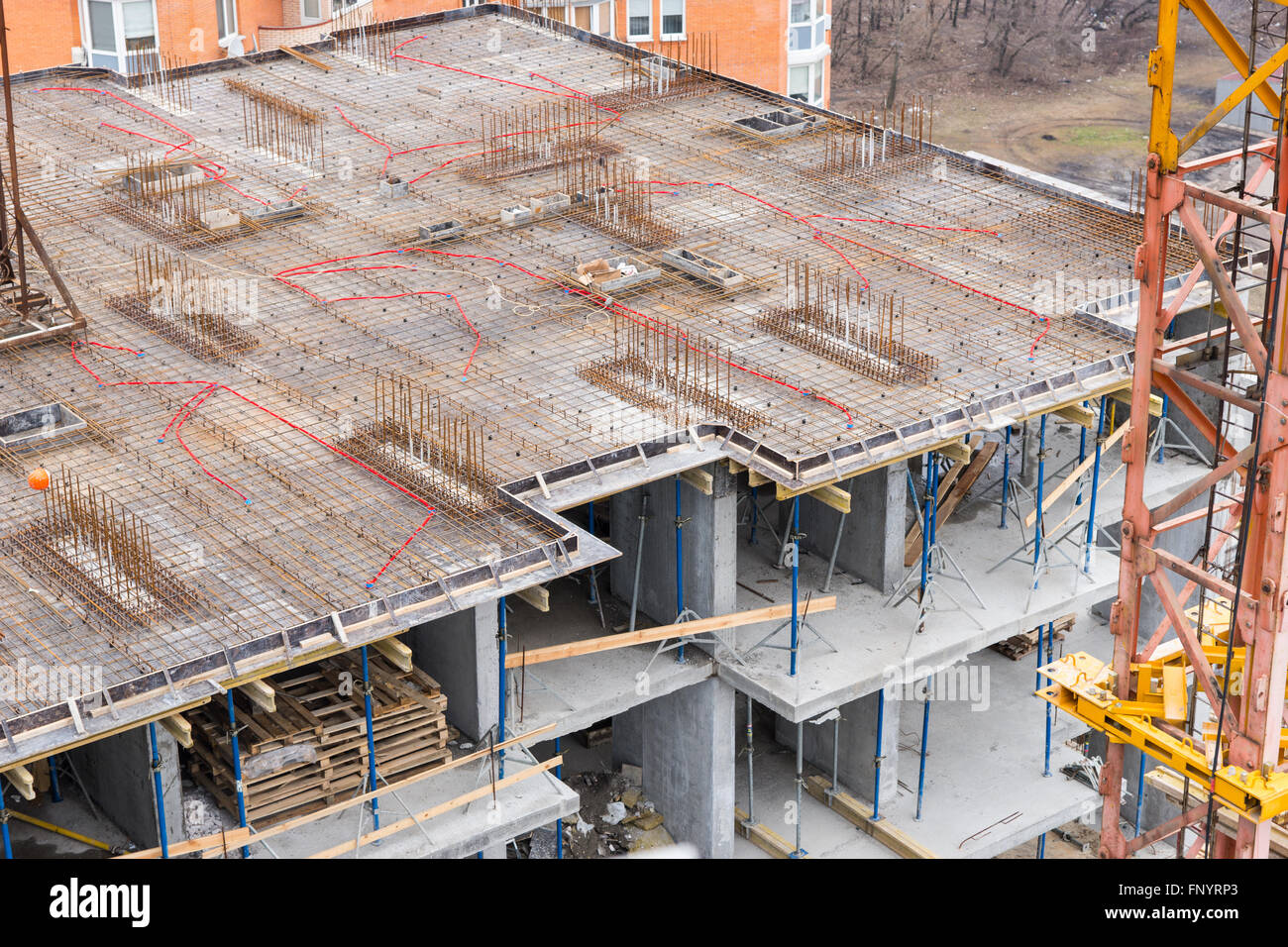Unfinished apartment floor with steel rods and concrete under