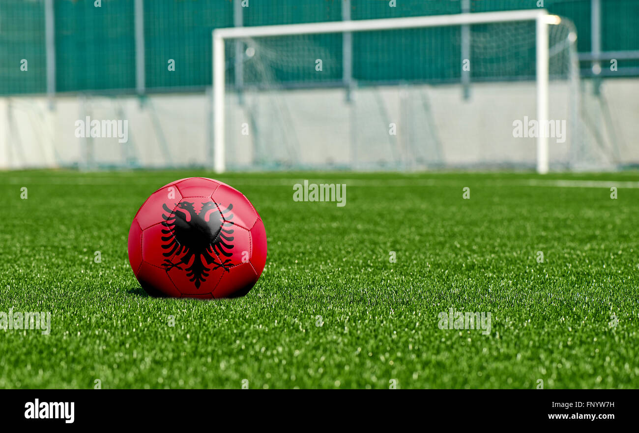 Soccer ball with the flag from Albania on the green field Stock Photo
