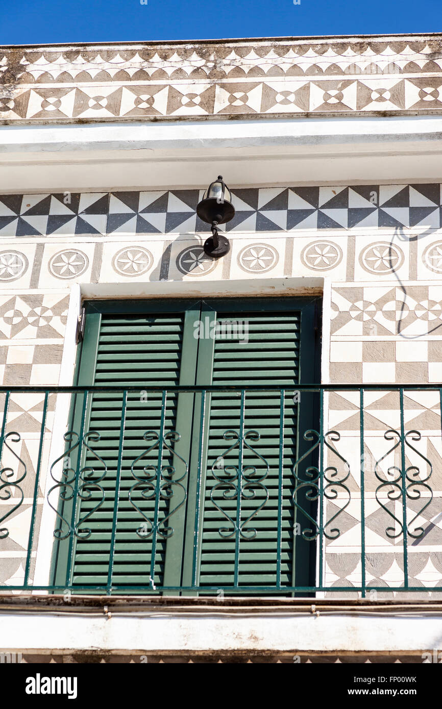 Window shutters, railings and decorative wall of a building in the