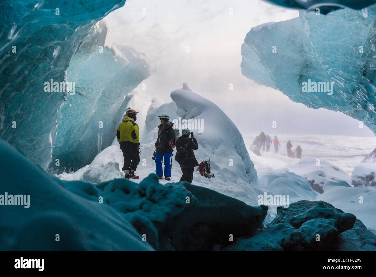 People at the entrance of an ice cave, Vatnajökull Nationalpark, Glacier, Iceland Stock Photo