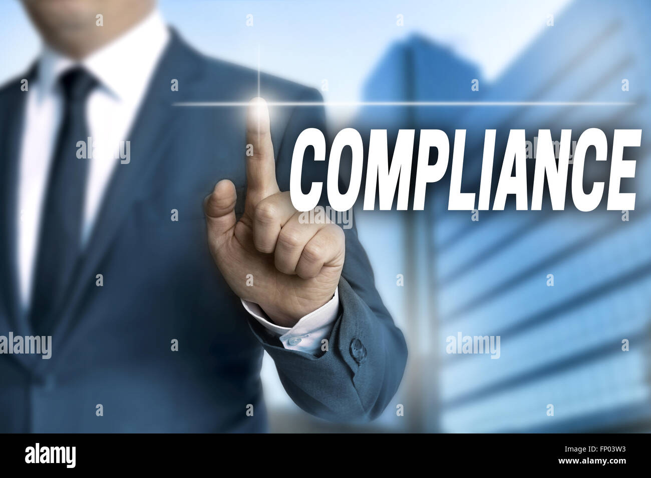 compliance touchscreen is operated by businessman. Stock Photo