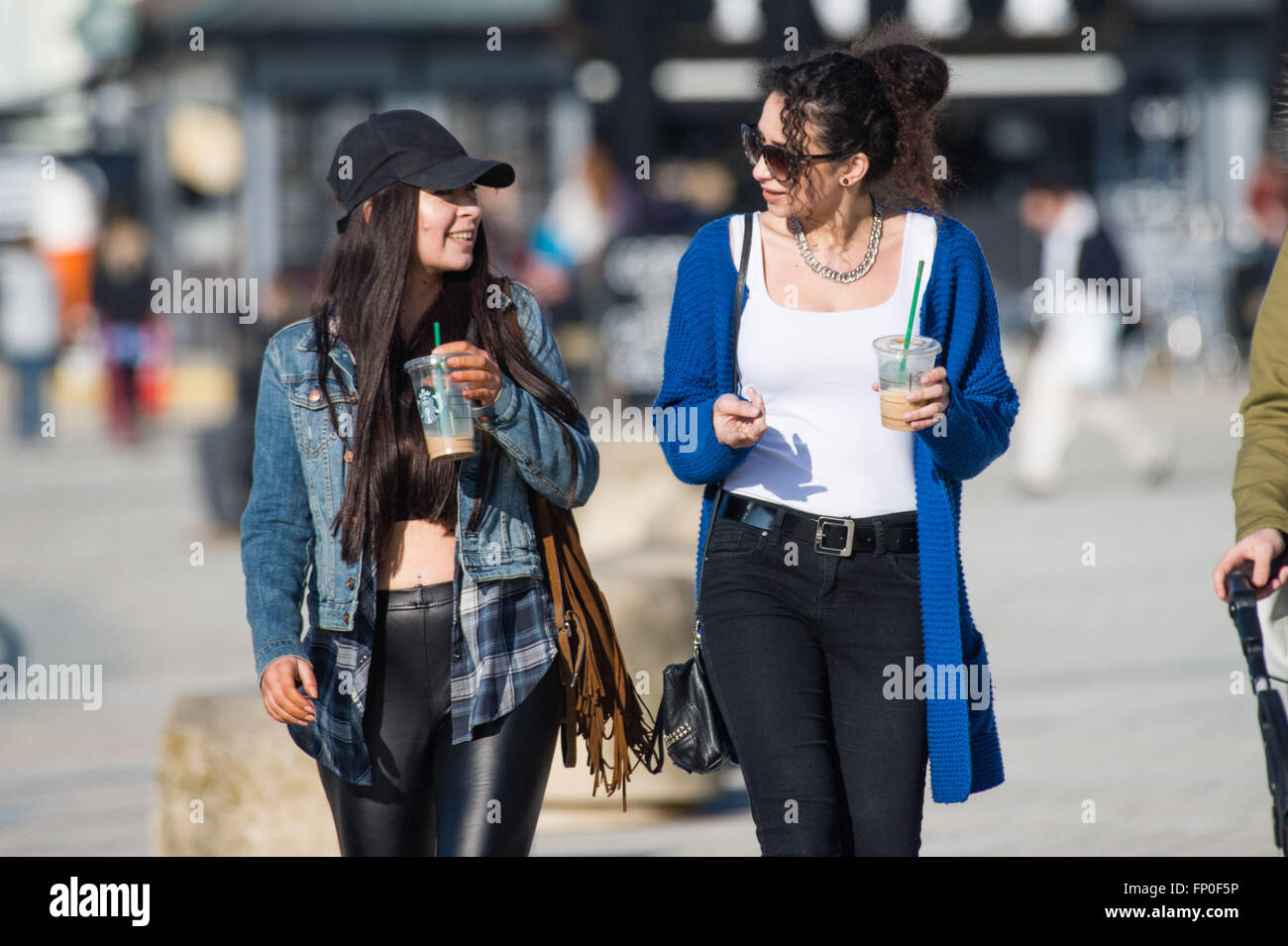Aberystwyth Wales UK, Wednesday  16 March 2016   UK weather: Two young women  enjoying the warm spring sunshine in Aberystwyth , west Wales UK.   On another day of clear skies and warm sunshine the the temperture reached a high of 13ºc   Credit:  keith morris/Alamy Live News Stock Photo