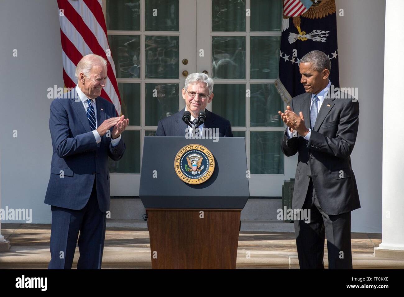 Washington DC, USA. 16th March, 2016. U.S. President Barack Obama and Vice President Joe Biden applaud as Chief Judge Merrick B. Garland accepts the nomination to the United States Supreme Court in the Rose Garden at the White House March 16, 2016 in Washington, DC. Stock Photo