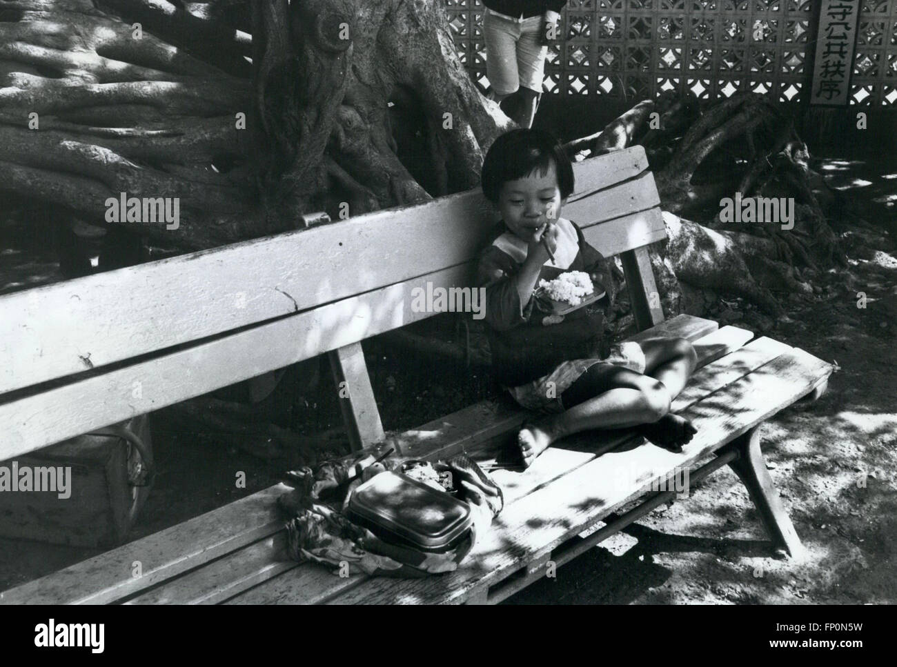 1962 - Taiwan, Kaohsuing. young girl eats lunch in the shade at one of island's many recreation parks. © Keystone Pictures USA/ZUMAPRESS.com/Alamy Live News Stock Photo
