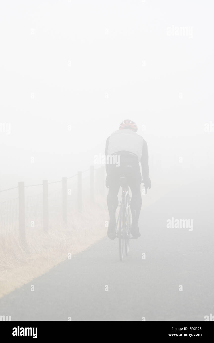 Crow Road, Campsie Fells, Stirlingshire, Scotland, UK. 17th March 2016. UK Weather: A still, misty morning in Stirlingshire, with fog on higher ground. The Crow Road is a difficult route full of climbs through the Campsie Fells popular with cyclists. Credit:  Kay Roxby/Alamy Live News Stock Photo