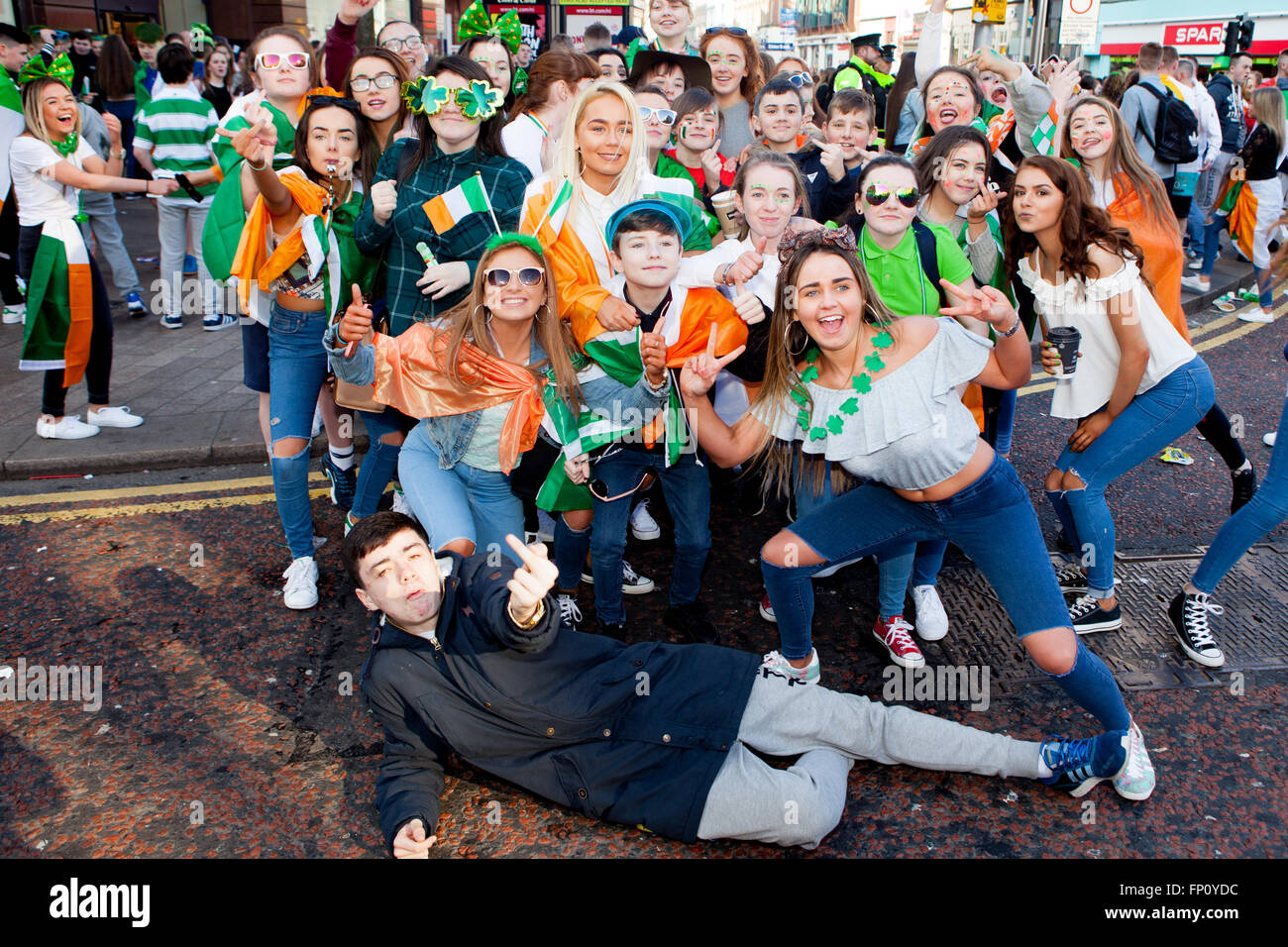 Belfast, Ireland. 17th March, Group of Teenage with Tri Colors wrapped around them at the Saint Patrick's Day Celebrations take place in Belfast Credit:  Bonzo/Alamy Live News Stock Photo