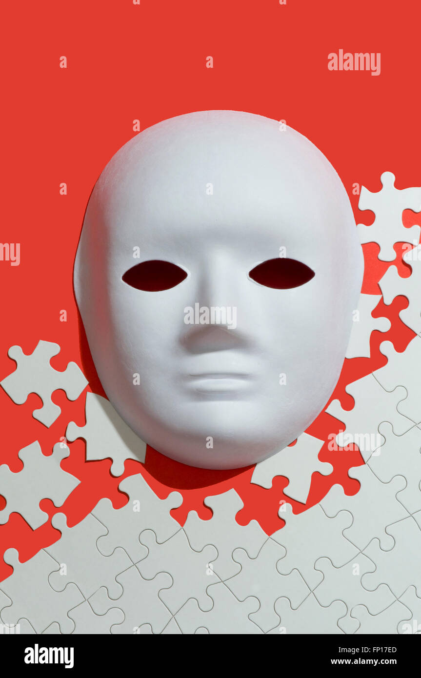 White face mask and puzzle pieces Stock Photo