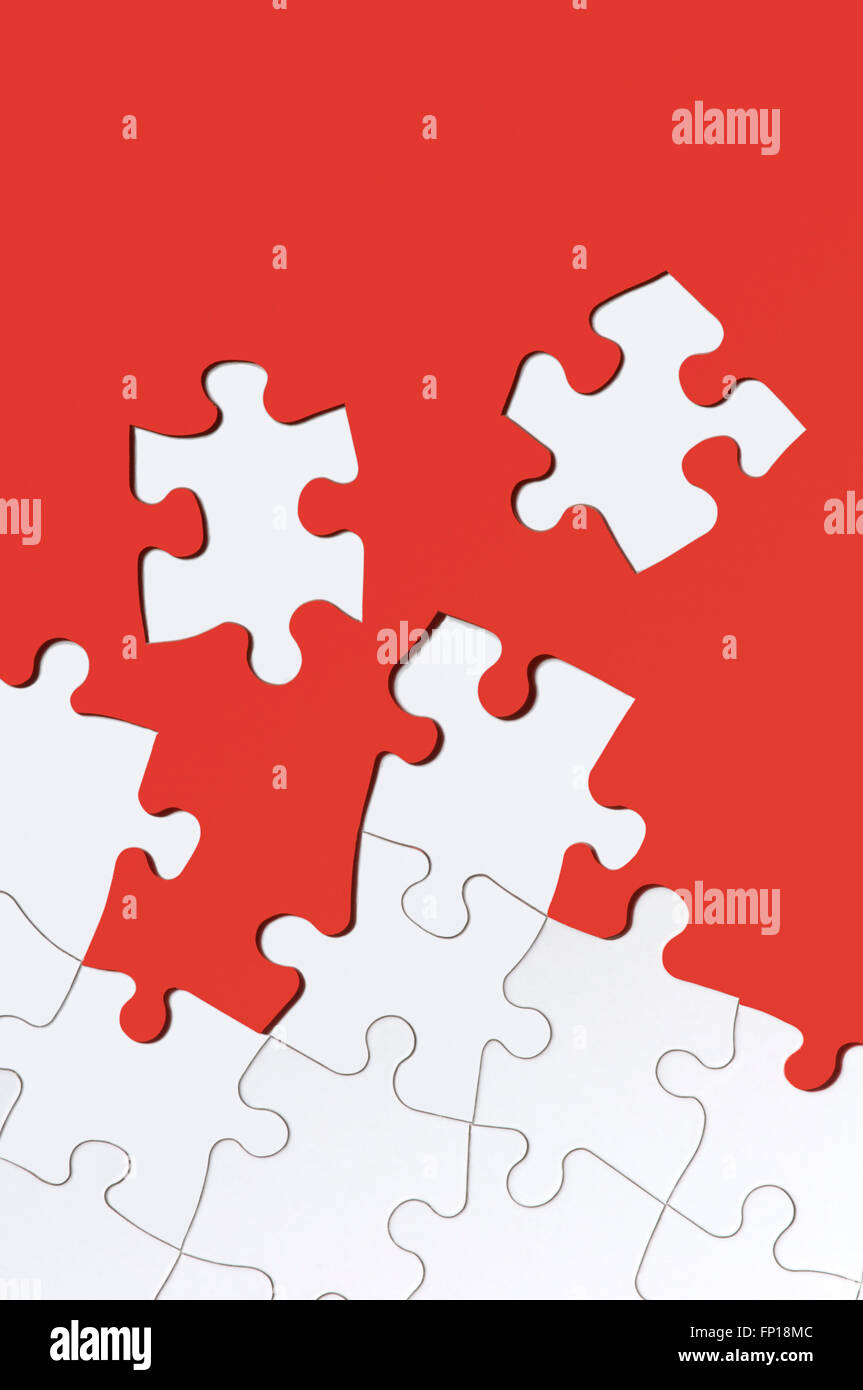 White jigsaw puzzle on red Stock Photo