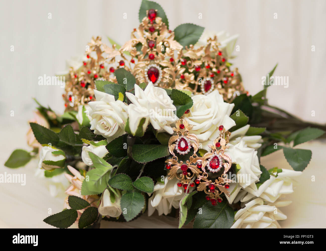 Bride golden crown with shining brilliants on rose bouquet Stock Photo