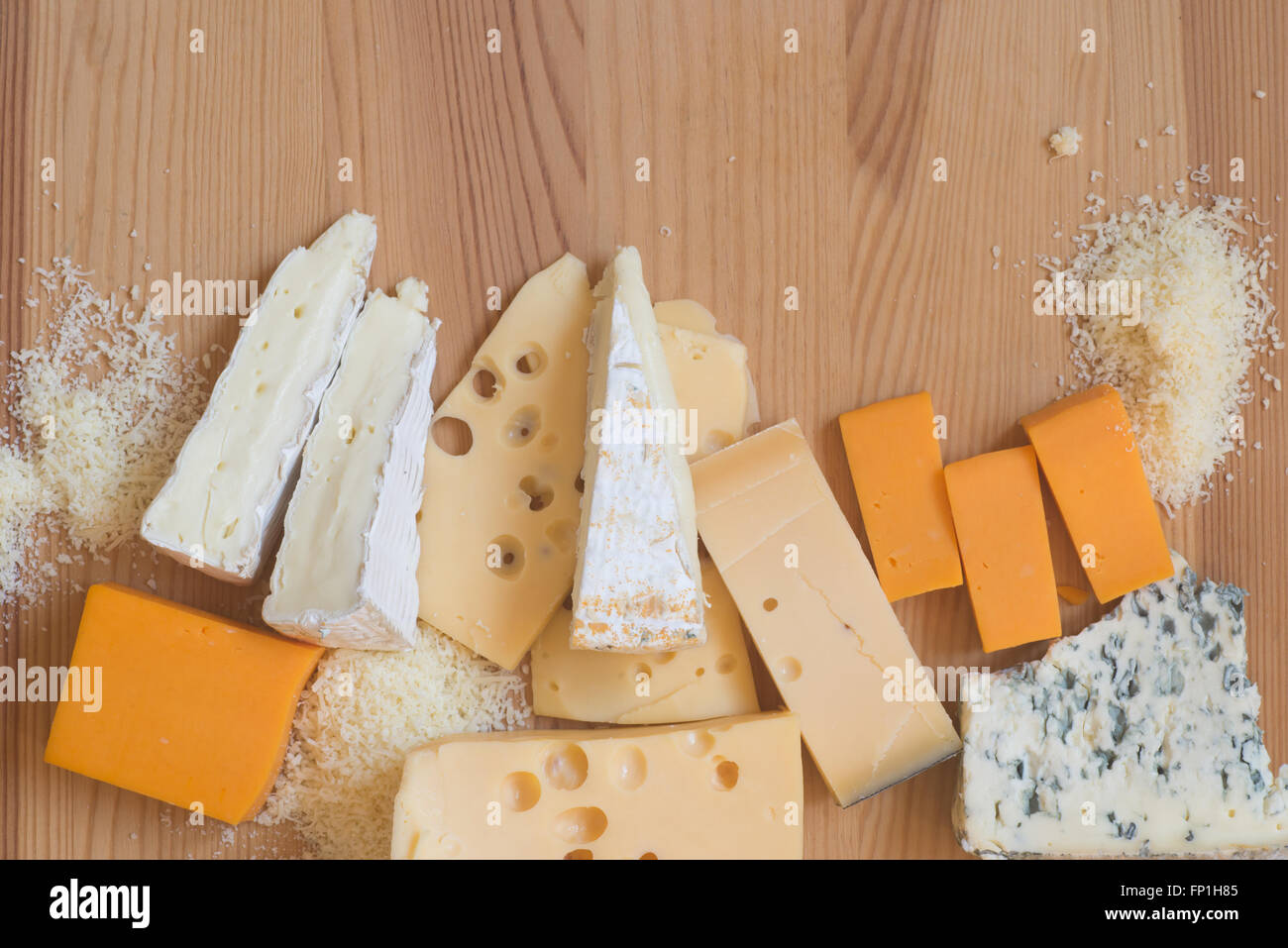 different types of cheese on wooden table Stock Photo
