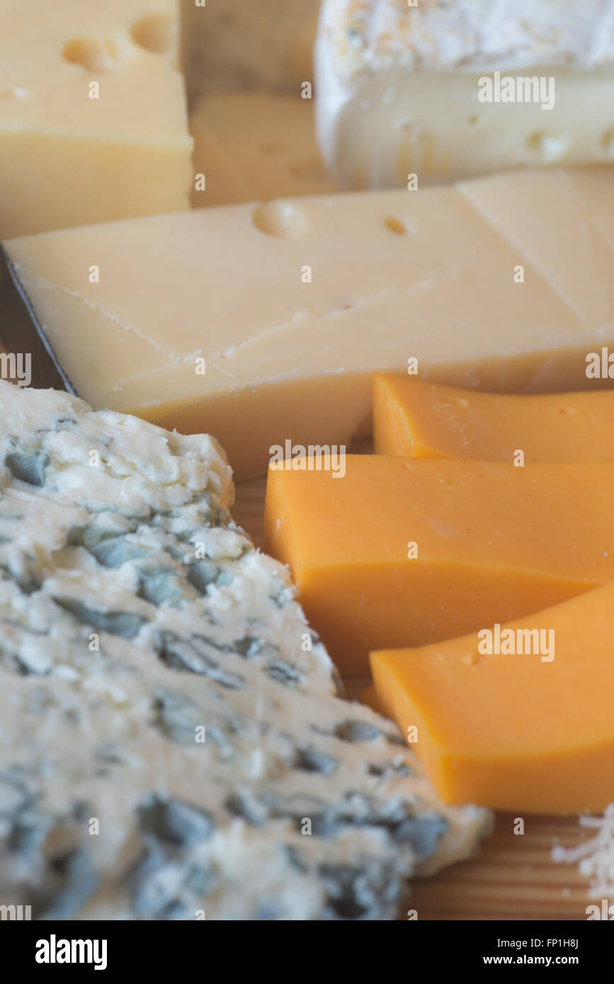 different types of cheese on wooden table Stock Photo