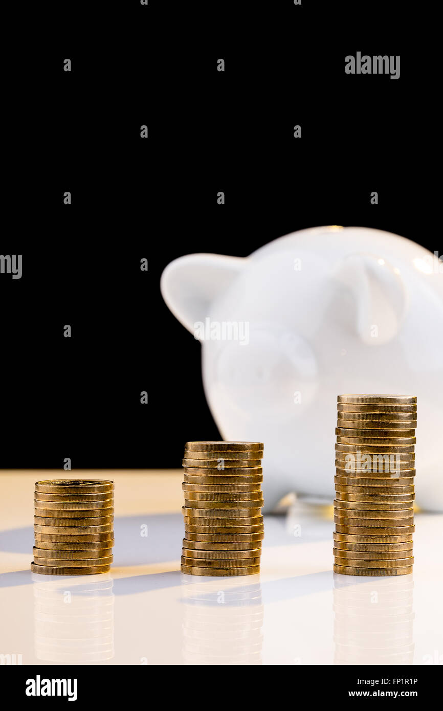 White piggy bank with stack of coins Stock Photo - Alamy