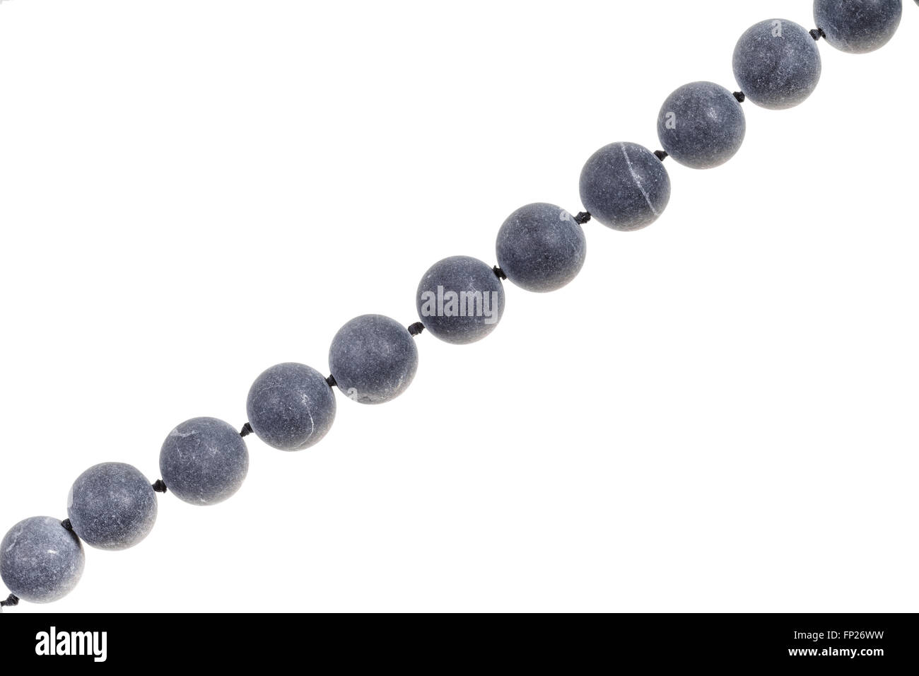 string of beads from gray Shungite gem stone isolated on white background Stock Photo