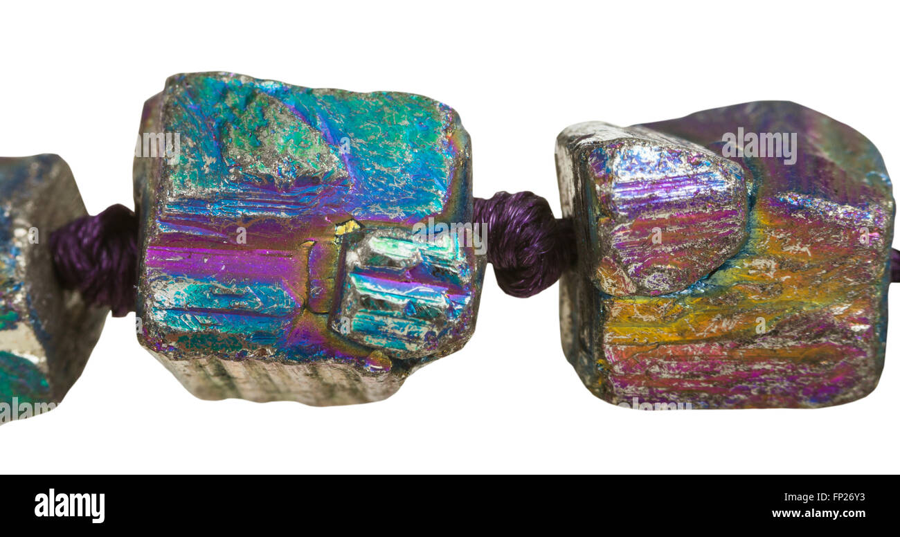 beads from iridescent (rainbow) pyrite gem stones close up isolated on