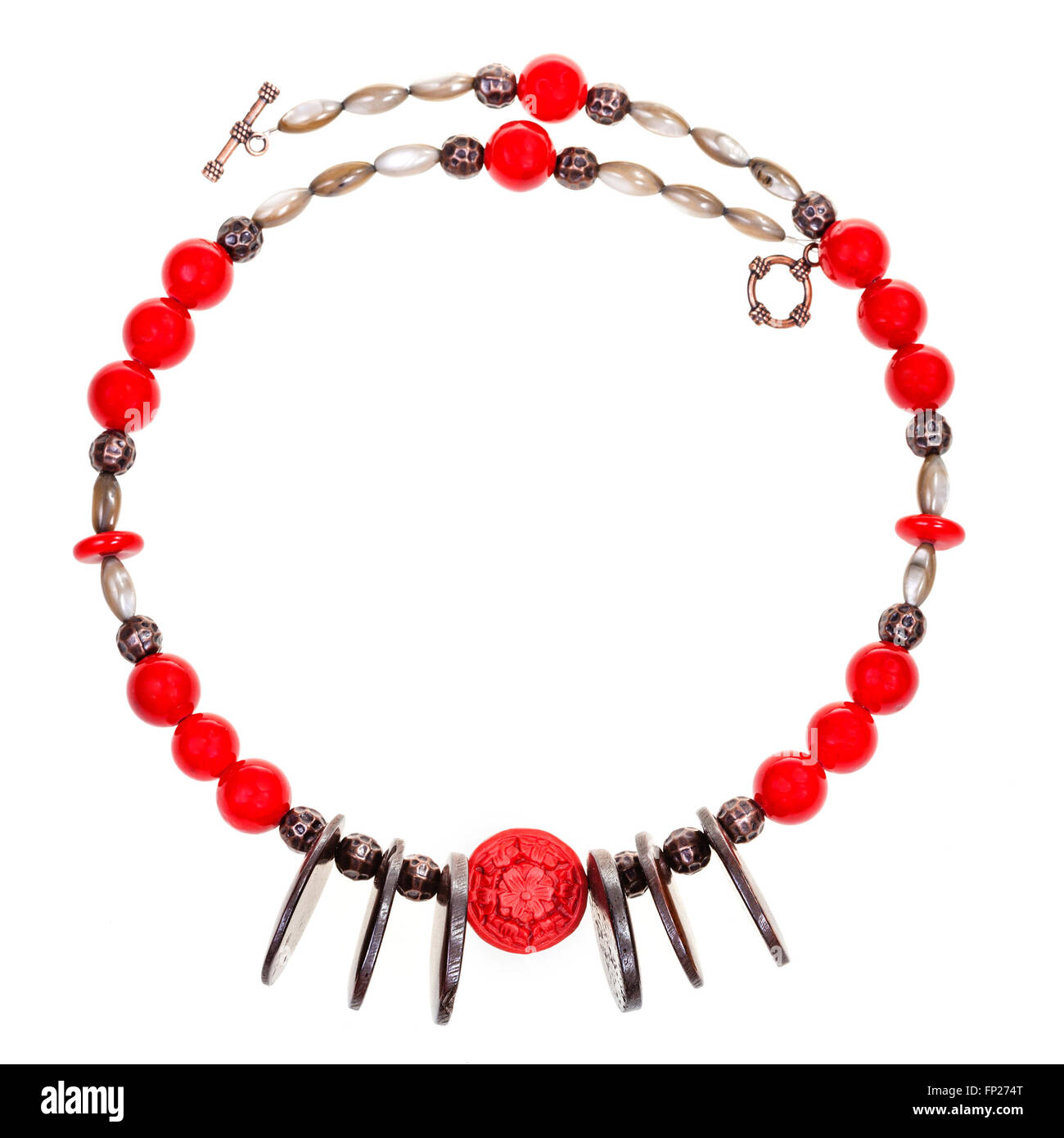 necklace from red coral, carved bone, nacre, copper beads isolated on white background Stock Photo