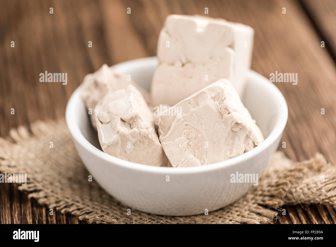Portion of fresh Yeast (selective focus) on wooden background Stock Photo