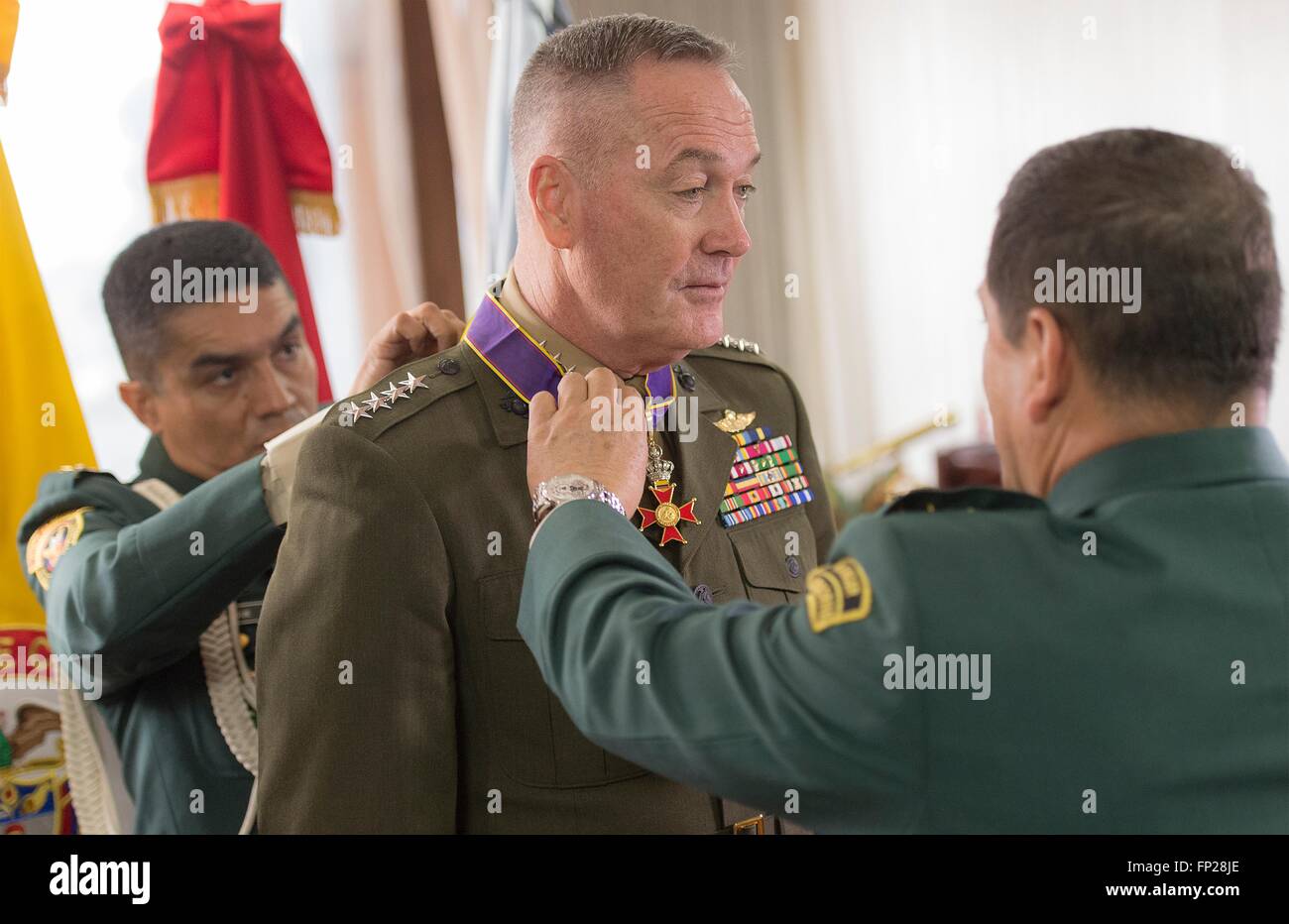 U.S. Chairman of the Joint Chiefs General Joseph Dunford is awarded the Fe en La Causa medal for his support of Colombian military efforts by Gen. Juan Pablo Rodriguez, general commander of the Armed Forces of Colombia, at the Headquarters of the Military Forces March 10, 2016  in Bogota, Colombia. Stock Photo