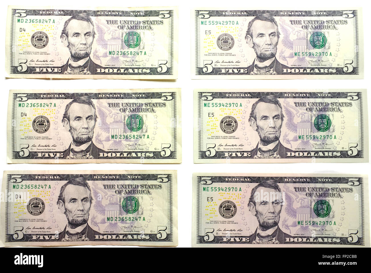 Six American Five Dollar notes photographed against a white background Stock Photo