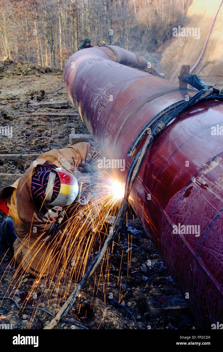 Man welding a pipeline seam in rural West Virginia; USA Stock Photo