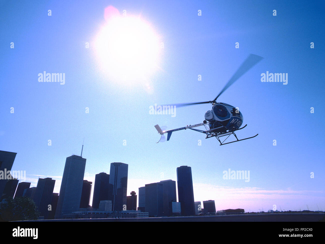 Houston Police helicopter taking off from top of tall building Stock Photo