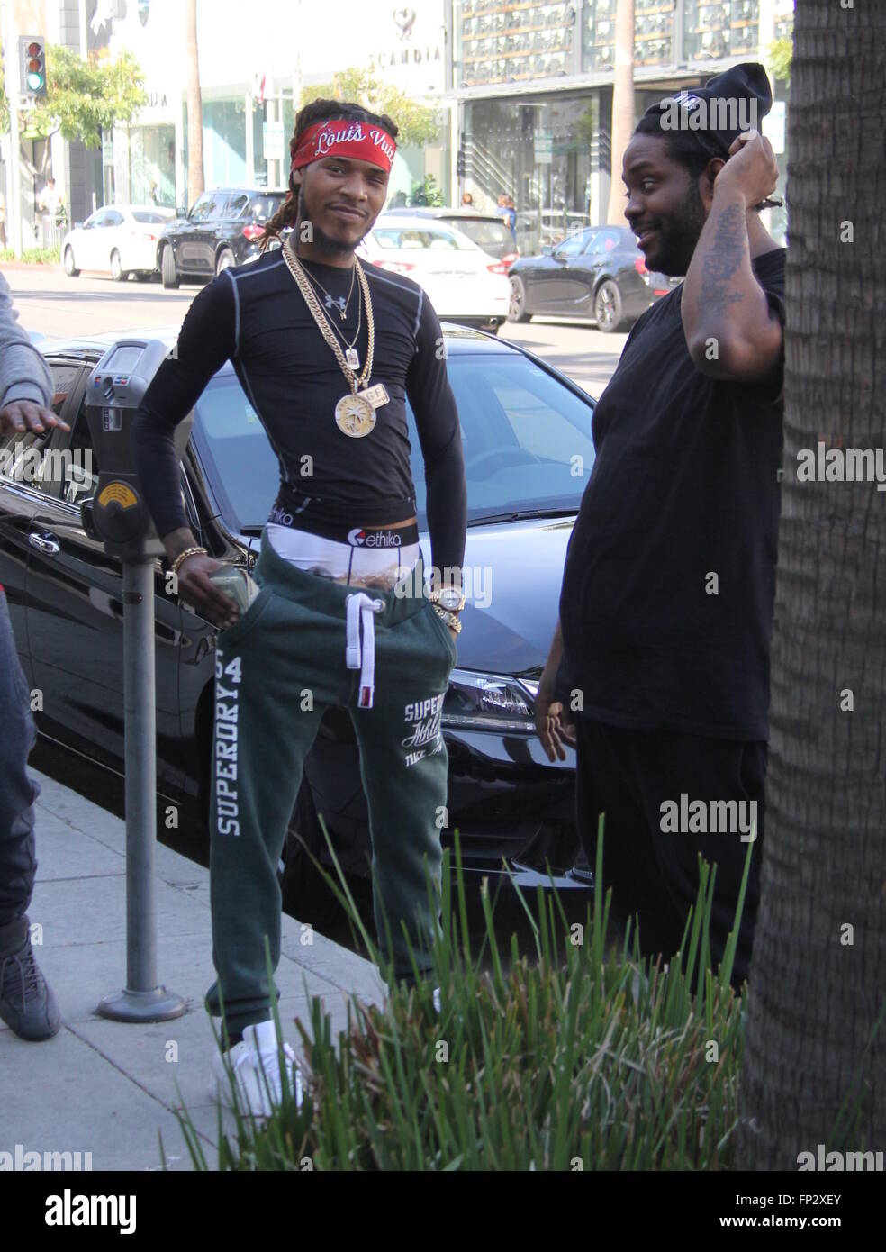 Rapper Fetty Wap flaunts two large wads of cash while out and about with  friends in