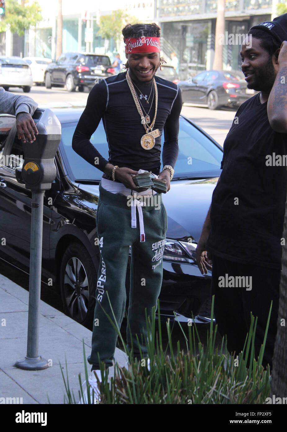 Rapper Fetty Wap flaunts two large wads of cash while out and about ...