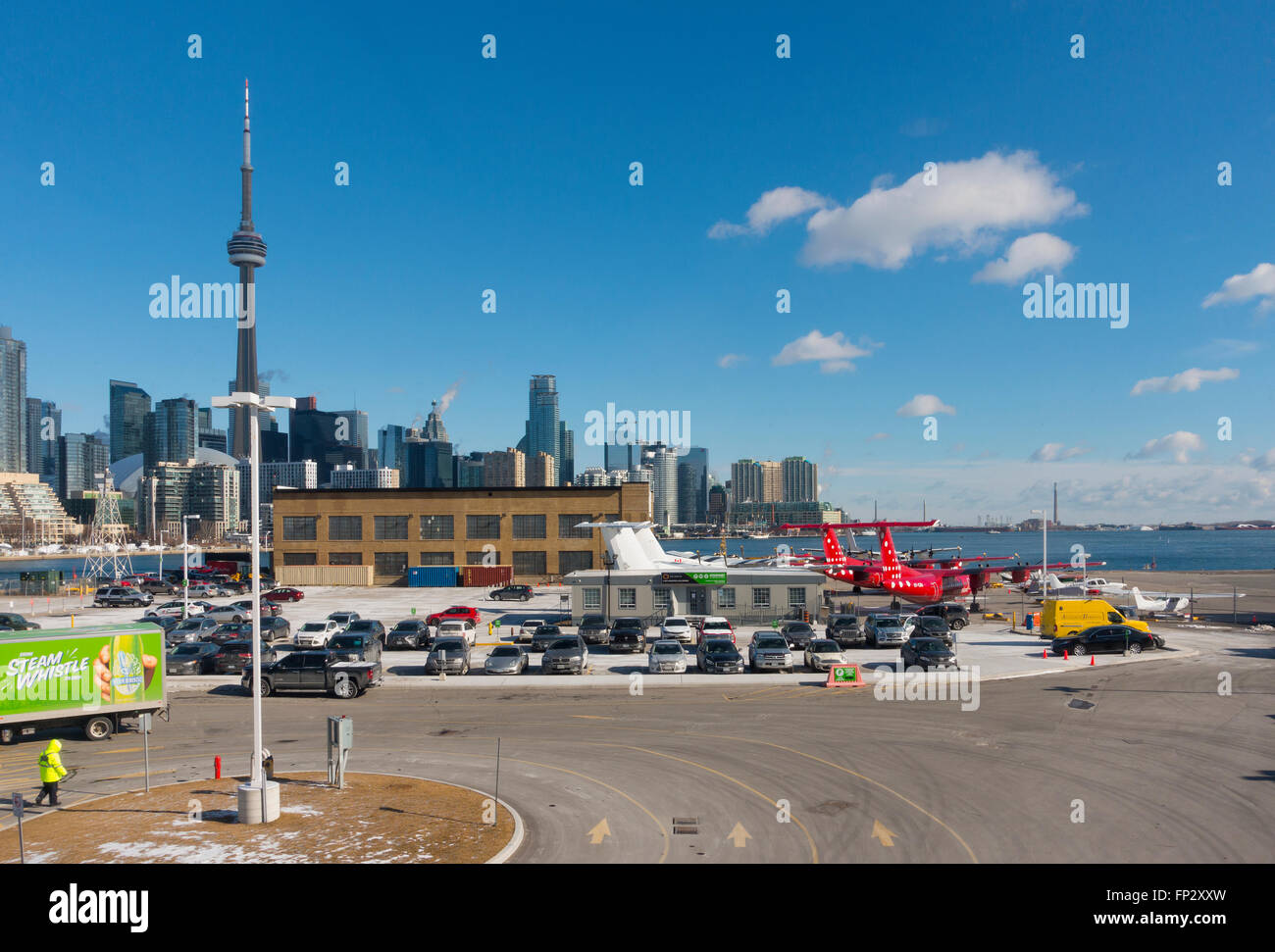 The Toronto skyline and planes from the Billy Bishop Toronto City Airport overlooking the parking lot. Toronto, Ontario, Canada. Stock Photo