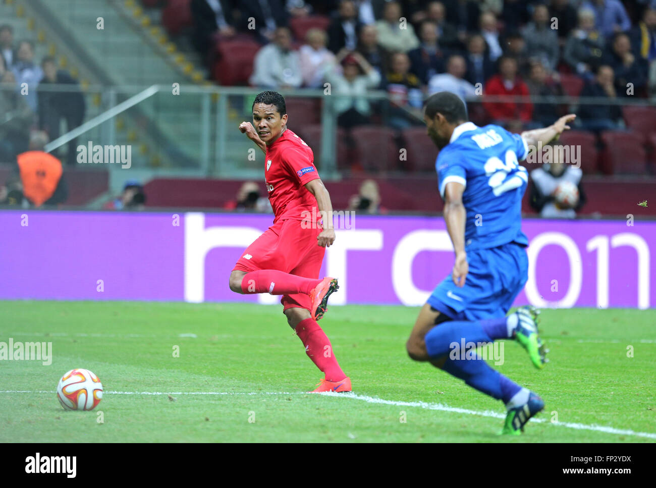 WARSAW, POLAND - MAY 27, 2015: Carlos Bacca (in Red) of FC Sevilla scores a goal during UEFA Europa League Final game against FC Dnipro at Warsaw National Stadium Stock Photo