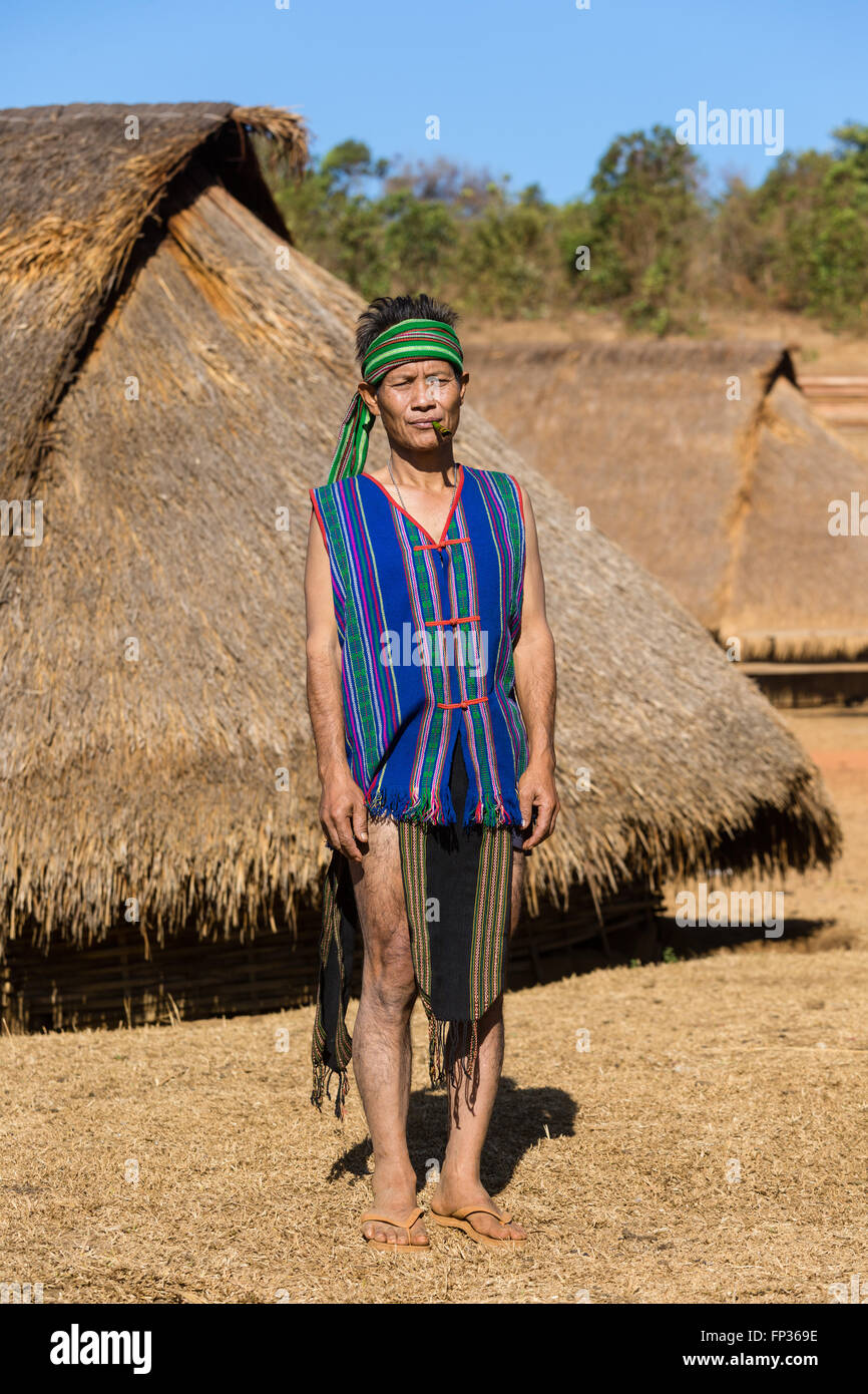 Man in traditional costume in front of a Phnong house, Ethnic minority, Pnong, Bunong, Senmonorom, Sen Monorom Stock Photo