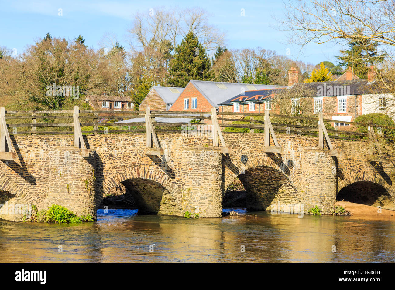 Medieval bridge over the River Wey, a scheduled monument in the small village of Tilford near Farnham, Surrey, UK Stock Photo