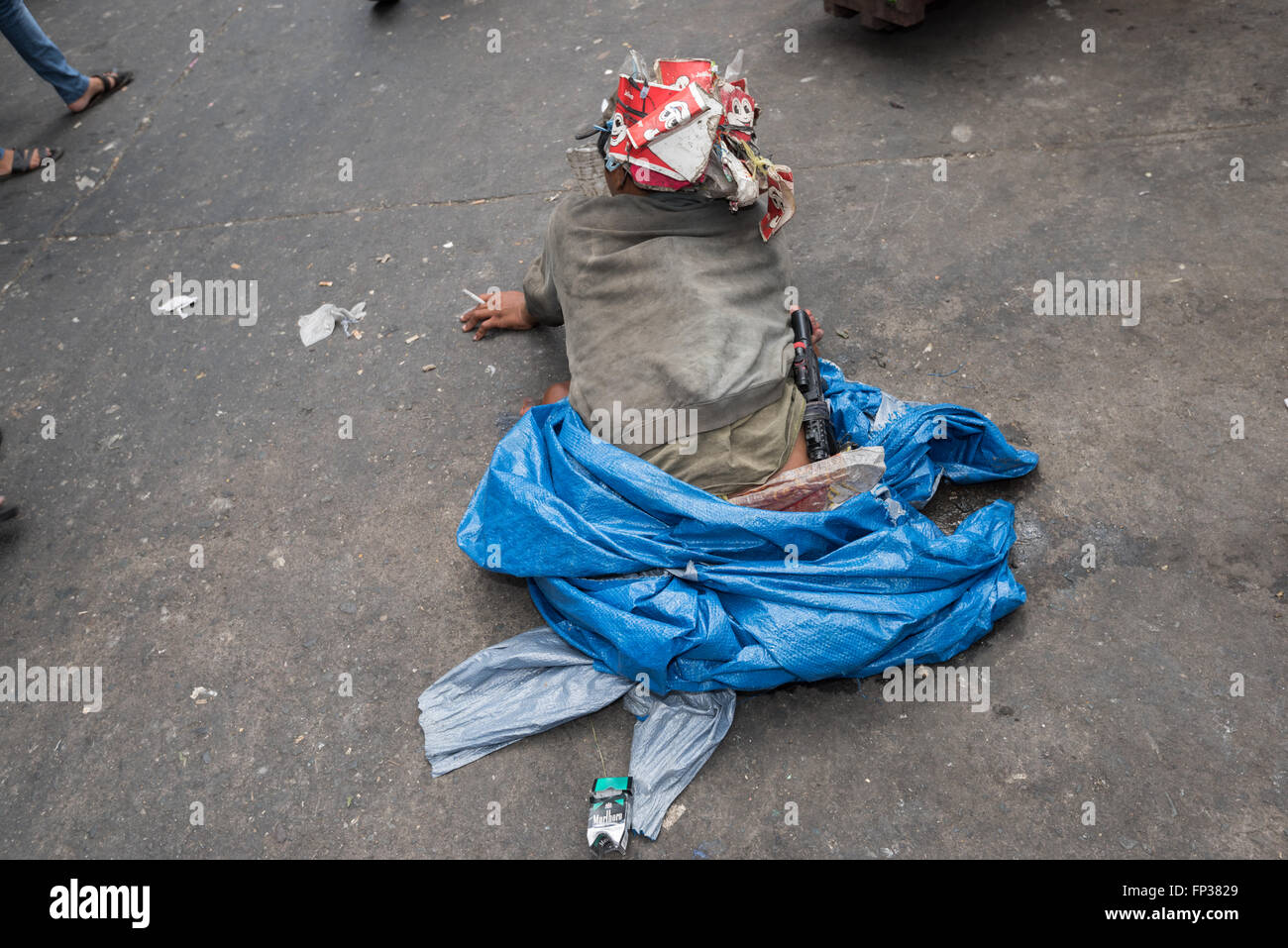 Manila; Philippines - March 13; 2016: Handicapped beggar on the street of Divisoria in Manila - Philippines. Stock Photo