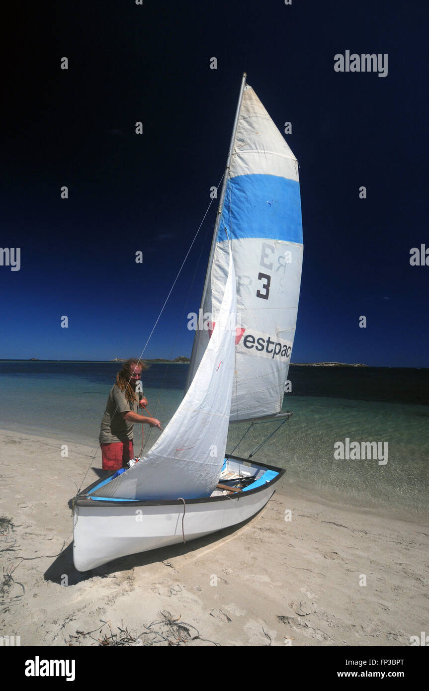 Rigging sails on dinghy on the beach at Point Peron, Shoalwater Islands Marine Park, Rockingham, near Perth, Western Australia. Stock Photo