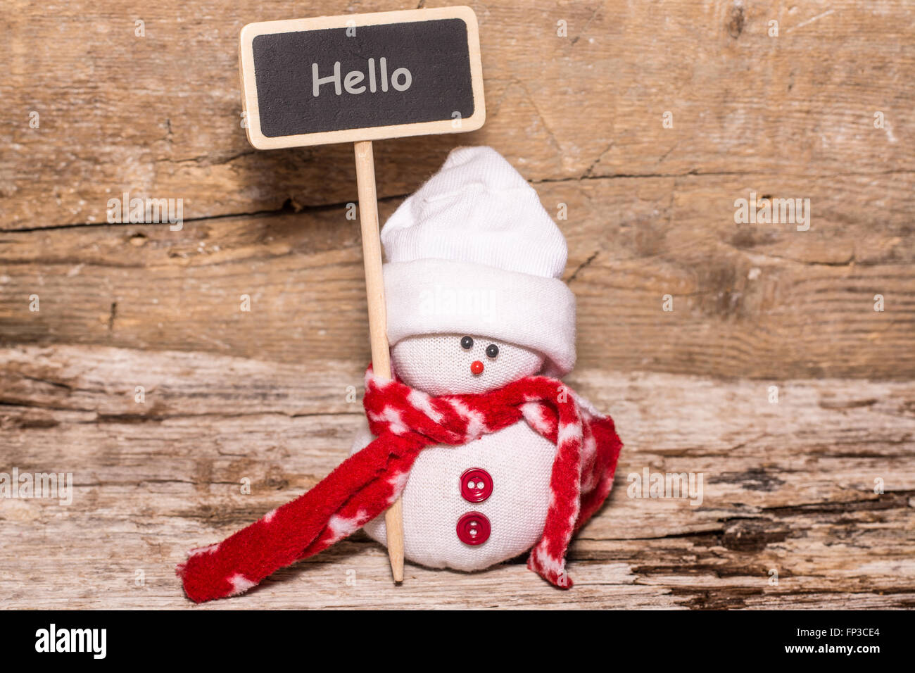 little snowman showing a sign with hello word Stock Photo