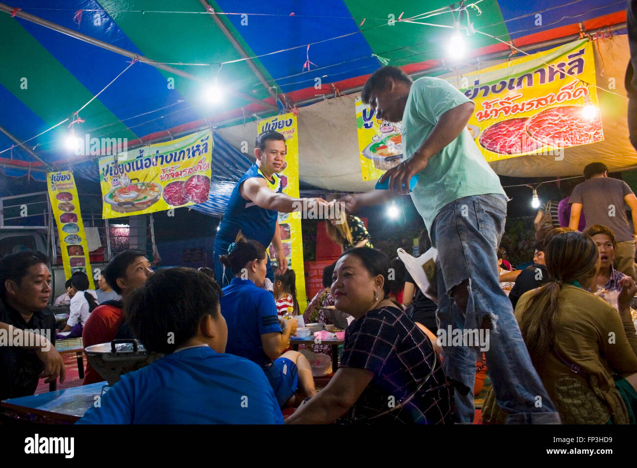 Cambodian people are gathered to eat food from Thailand at a street fair in Kampong Cham, Cambodia. Stock Photo