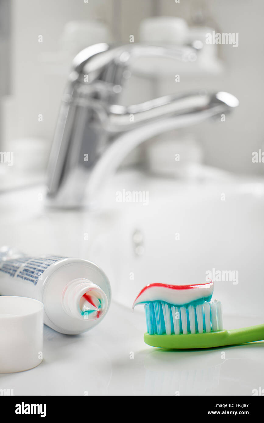Toothbrush and toothpaste in the bathroom close up. Stock Photo