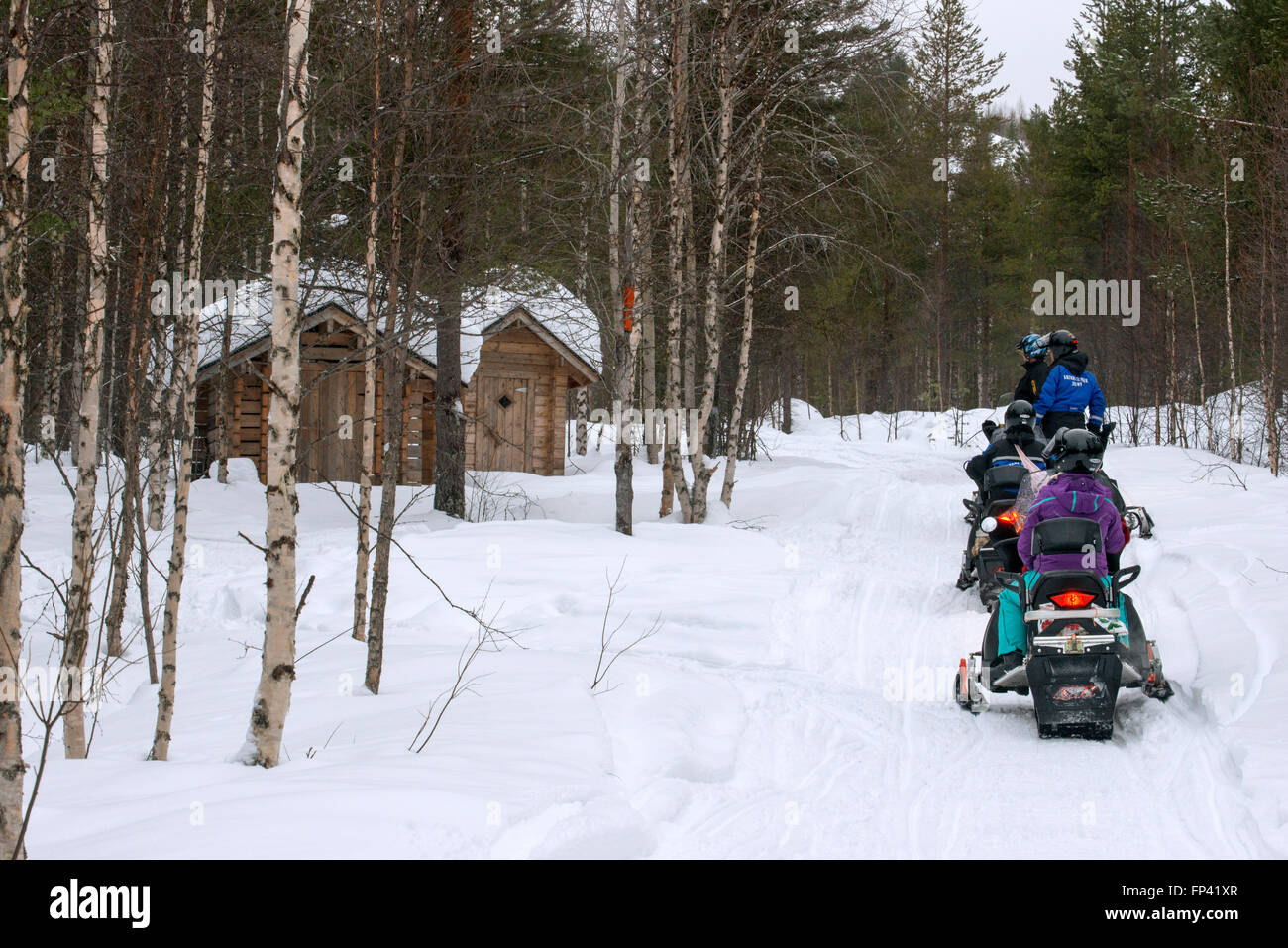 Snowmobiles safaris at Salla, Lapland, Finland. Guided snowmobile safaris are a safe way to explore the wilderness near and far. Stock Photo