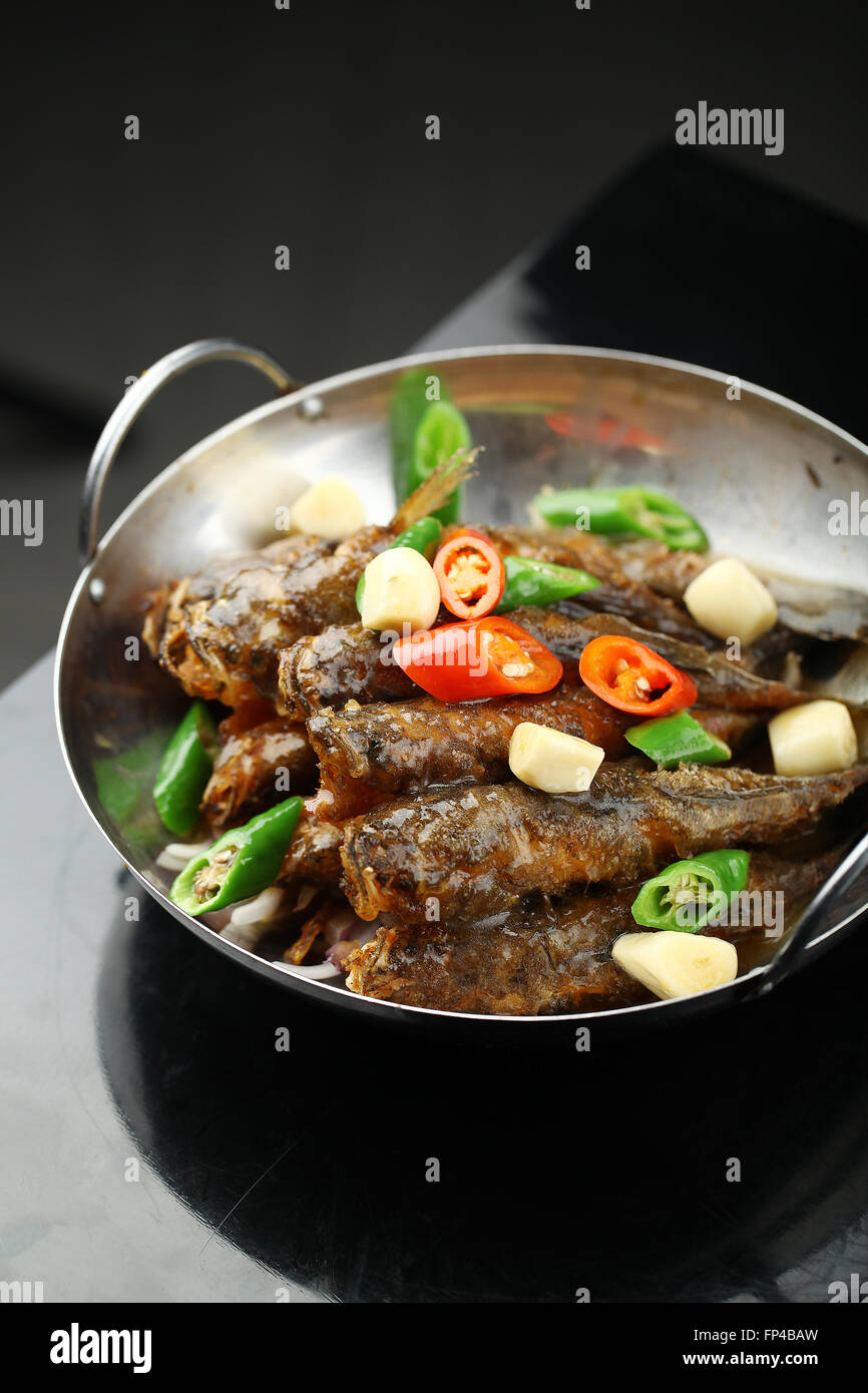 Fried fish served in a wok Stock Photo Alamy