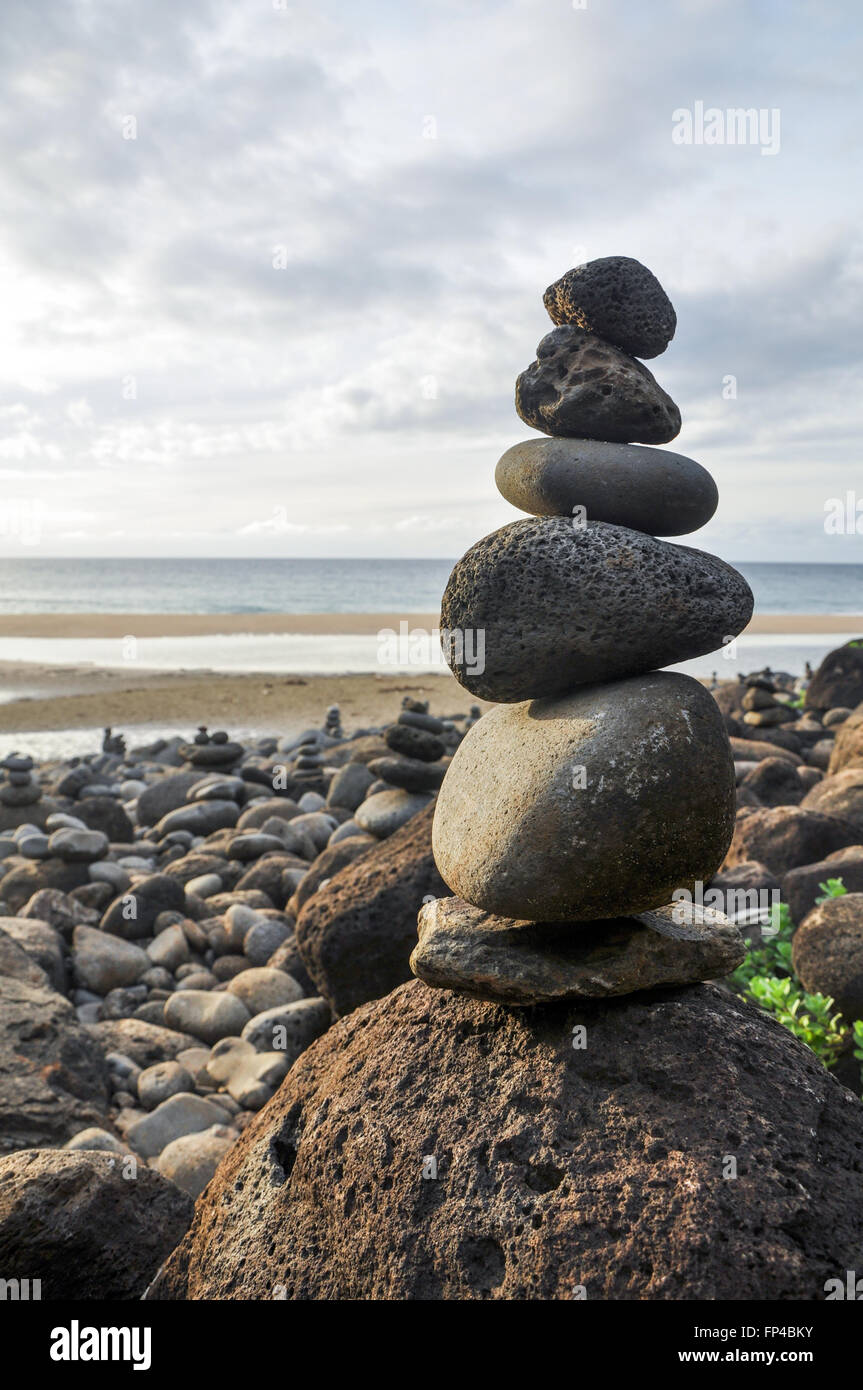Stacked round rocks at Hanakapiai beach, Kauai, Hawaii Stock Photo