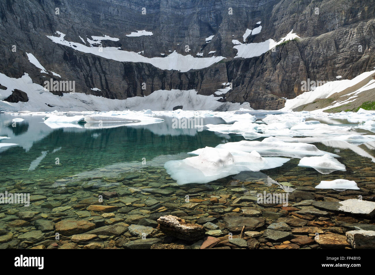 Iceberg Lake in Glacier National Park with small icebergs in the water Stock Photo