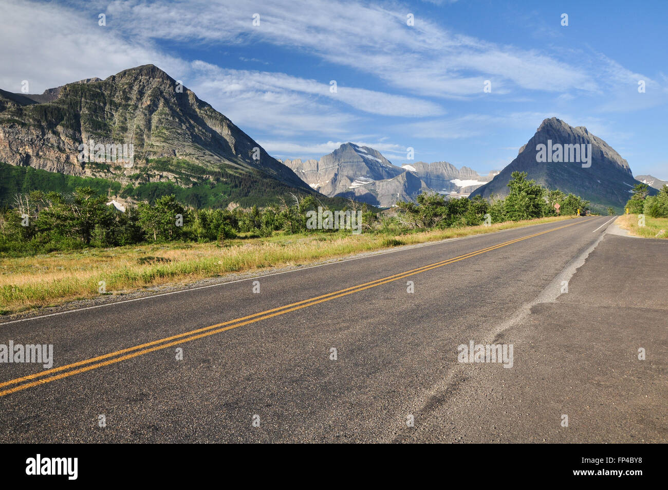 Long straight road with mountain view in Glacier National Park Stock Photo