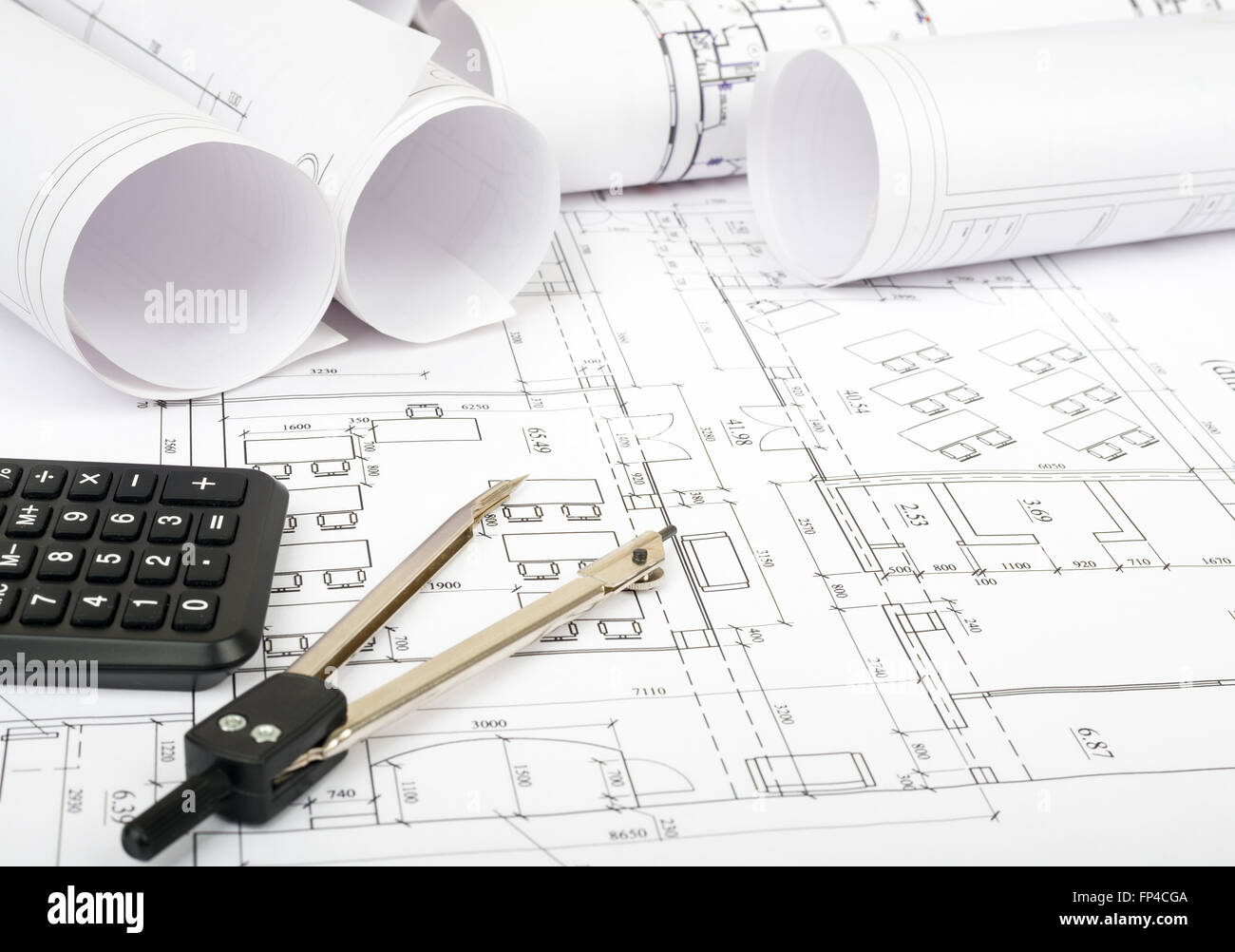 Construction Blueprint Math Blueprints and rolls of blueprints with divider and calculator ...