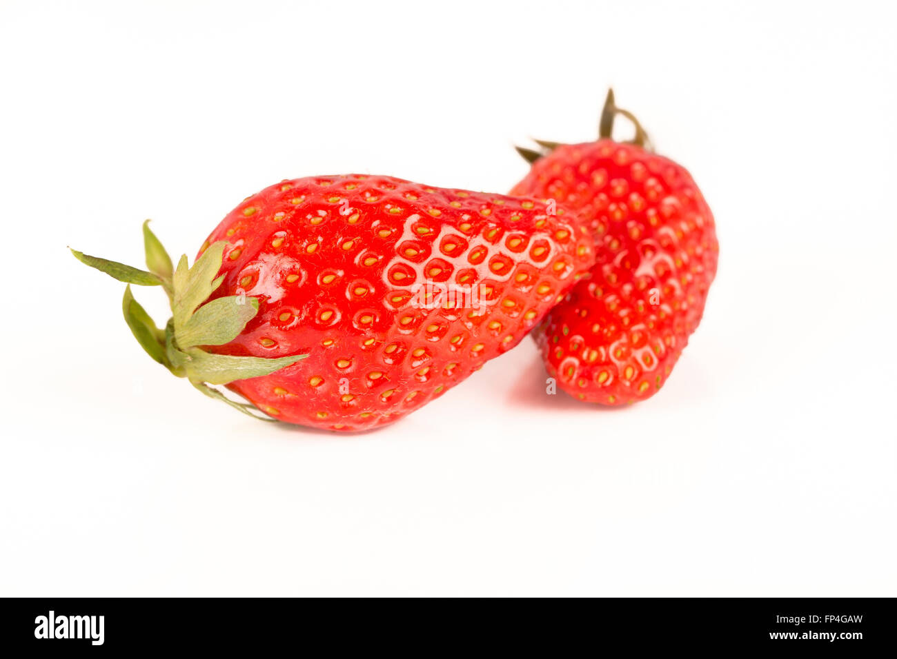 Two strawberries close up on white background France Stock Photo - Alamy