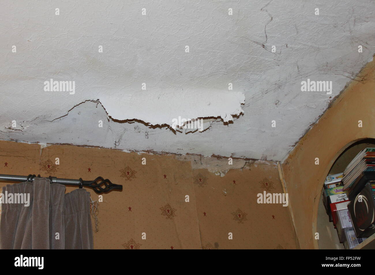 Damp Wall And Ceiling With Wallpaper Coming Away Stock Photo