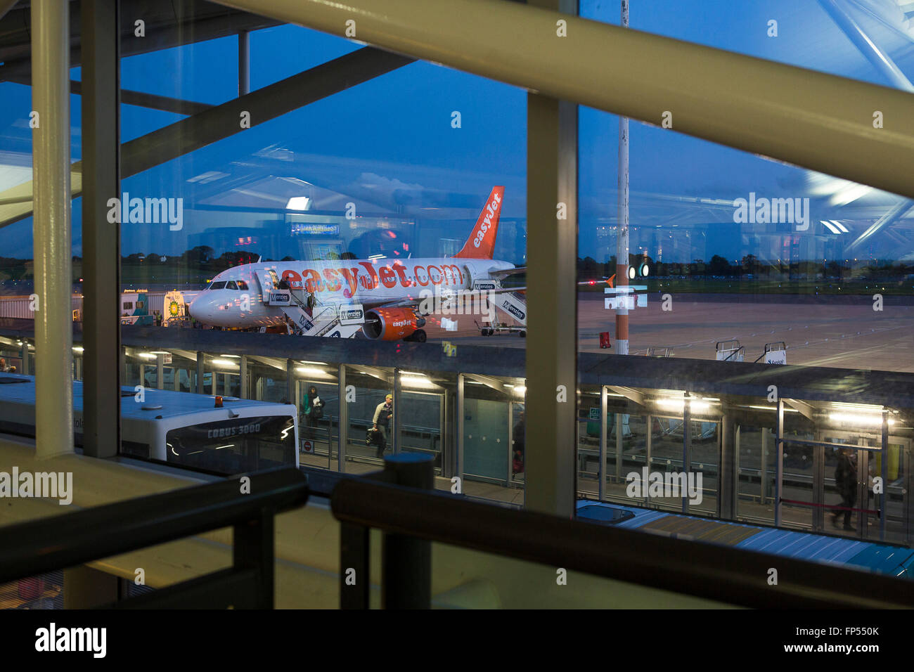 An Easy Jet airliner stands on the concrete at Bristol International airport as night falls making ready for its next flight. Stock Photo